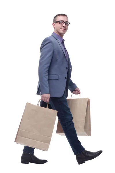 Joven hombre de negocios con jeans y gafas con bolsas de compras — Foto de Stock