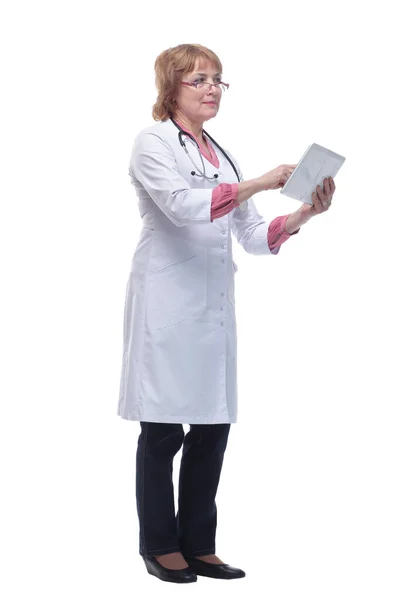 Happy doctor in lab coat and glasses using tablet pc — Stock fotografie