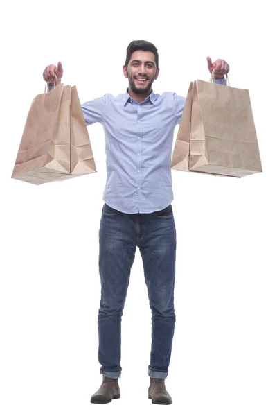 幸せな若者がショッピングバッグを見せて. — ストック写真