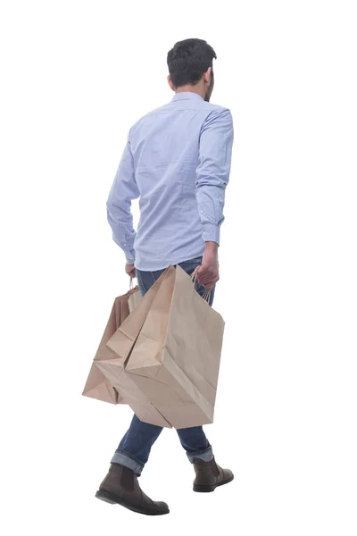 Οπίσθια όψη. άνθρωπος με τσάντες ψώνια με τα πόδια μακριά. — Φωτογραφία Αρχείου