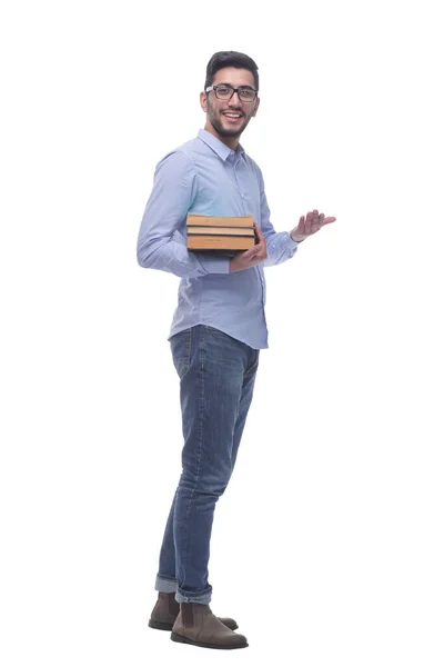Przypadkowy młody człowiek z stosem książek. — Zdjęcie stockowe