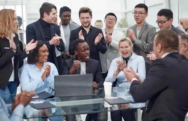 Happy multi-ethnic business people around a conference table
