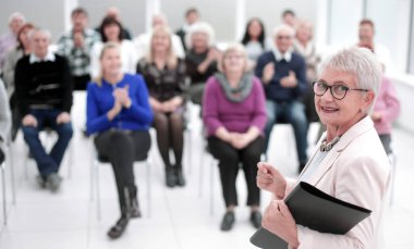 İş kadını ofis toplantısında meslektaşlarına sesleniyor
