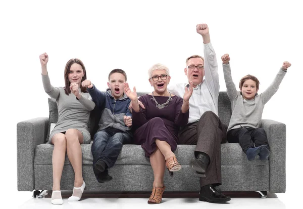 Happy family sitting on a large comfortable sofa. — Stock Photo, Image