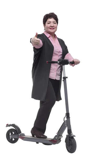 In full growth. confident mature woman with an electric scooter — Stock Photo, Image