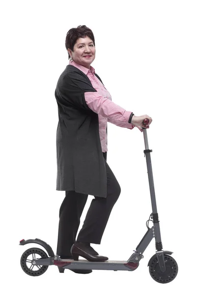 Side view. mature woman with an electric scooter reading an ad on a white screen — Stock Photo, Image