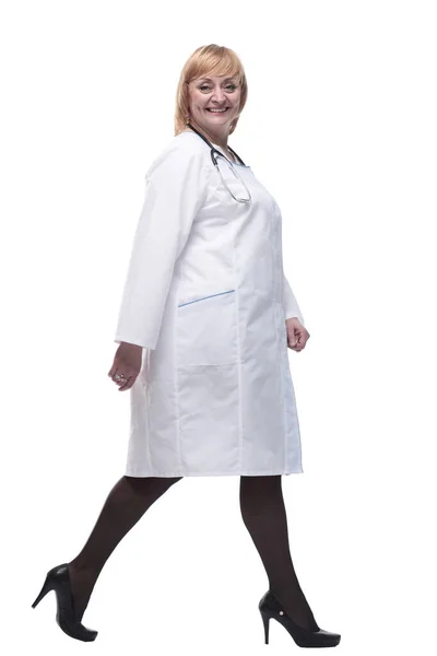 In full growth. friendly woman doctor striding forward. Stock Picture