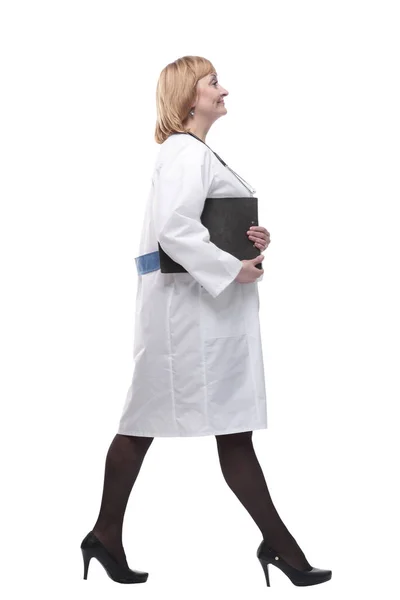 In full growth.friendly medical doctor woman with a clipboard steps forward. Stock Image