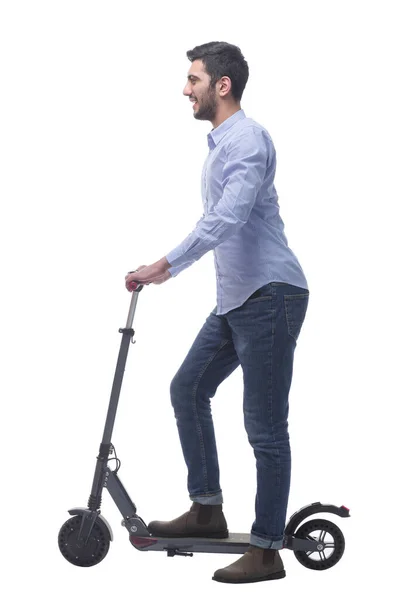 Vue latérale. attrayant jeune homme avec un scooter électrique. — Photo