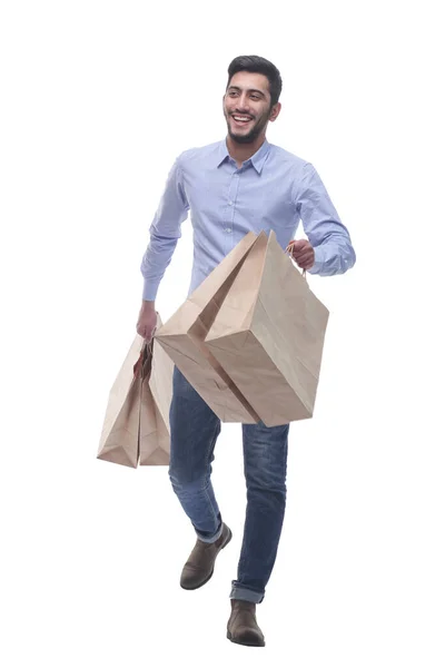 Jongeman met boodschappentassen naar voren. — Stockfoto