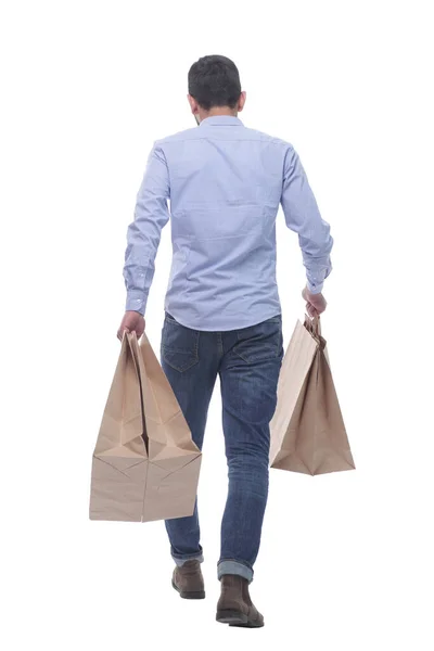 Vista posteriore. uomo con borse della spesa che se ne va. — Foto Stock