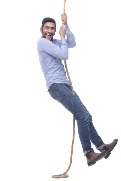 In volle groei. gelukkig jongeman klimmen een touw. — Stockfoto