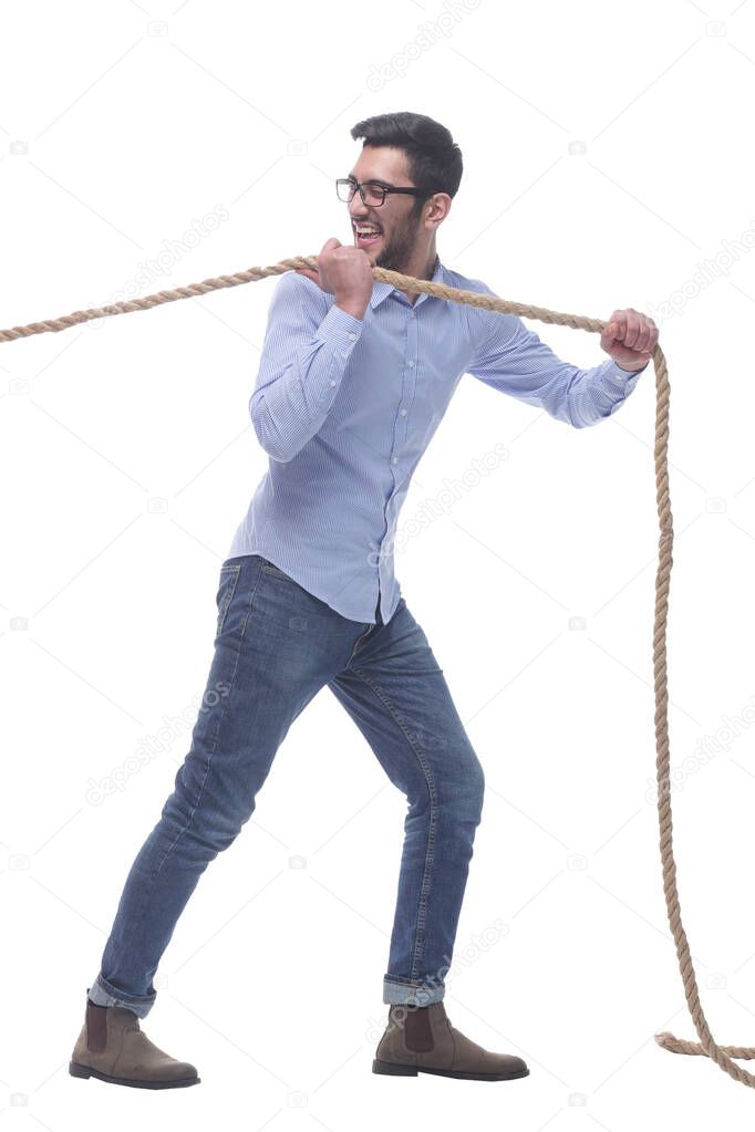 purposeful young man pulls the rope. isolated on a white background.