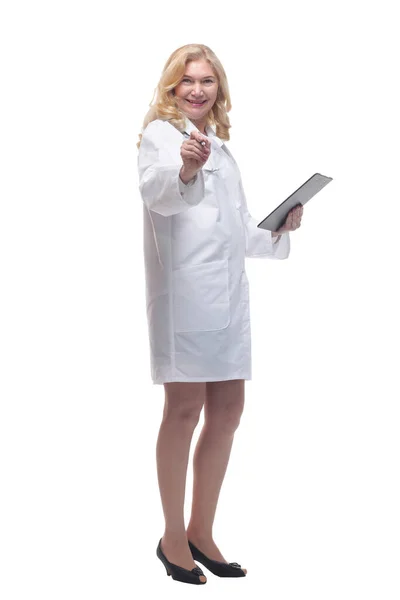 Friendly woman doctor making a note in the clipboard . Royalty Free Stock Images