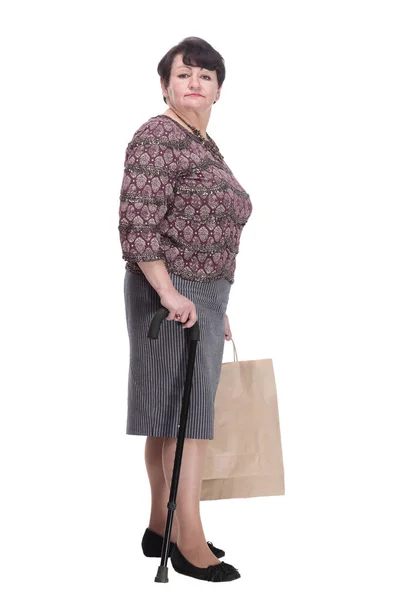 Elderly woman with a walking stick and shopping bags. — Stock Photo, Image