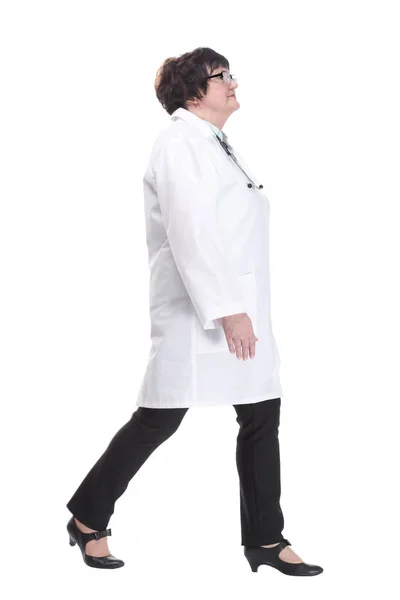 Older female doctor with a stethoscope walks forward. — Stock Photo, Image