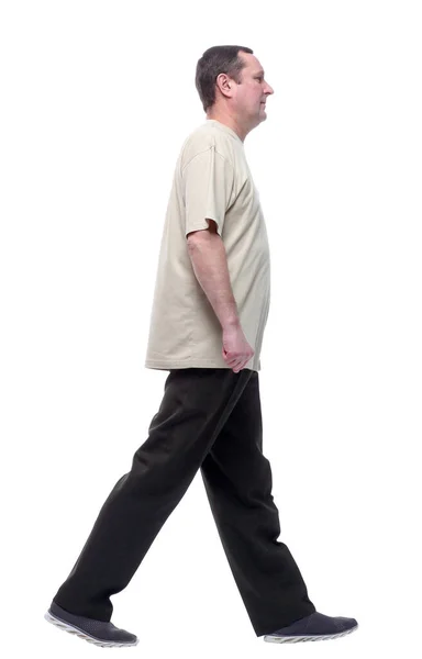 In full growth. a man in a light t-shirt striding forward. — Stock Photo, Image
