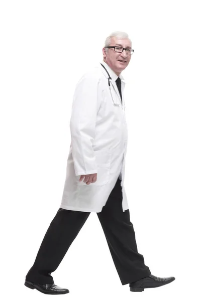 Qualified mature doctor with stethoscope stepping forward. Stock Image