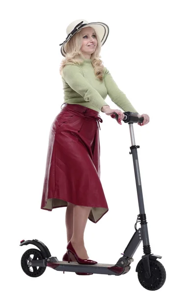 Fashionable woman in a summer hat using an electric scooter — Stock Photo, Image