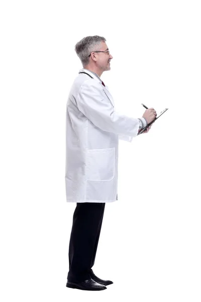 Leende läkare gör anteckningar i klippbordet. isolerad på en vit — Stockfoto