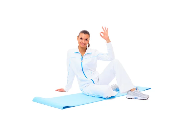 Fitness-Frau macht Pause im Schneidersitz auf weißem Hintergrund — Stockfoto