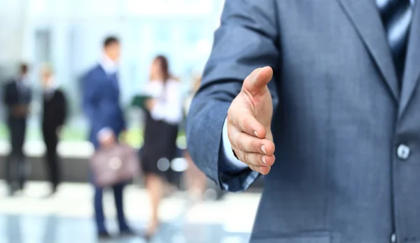 Businessman extending hand to shake — Stock Photo, Image