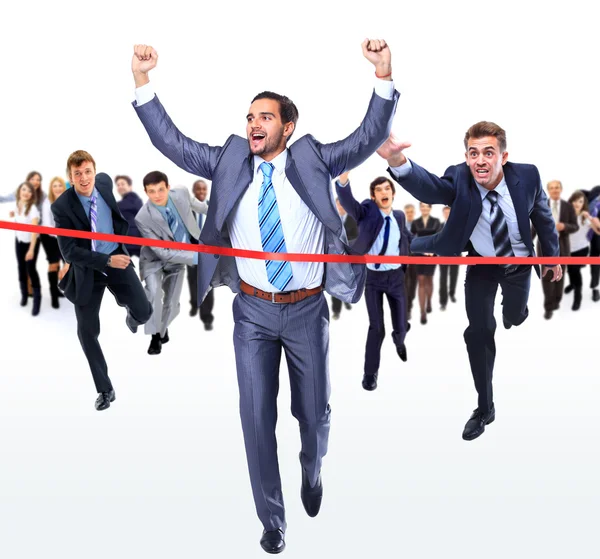 Happy businessman running through finishing line — Stock Photo, Image