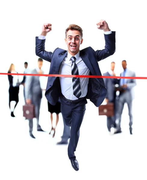 Happy businessman running through finishing line — Stock Photo, Image