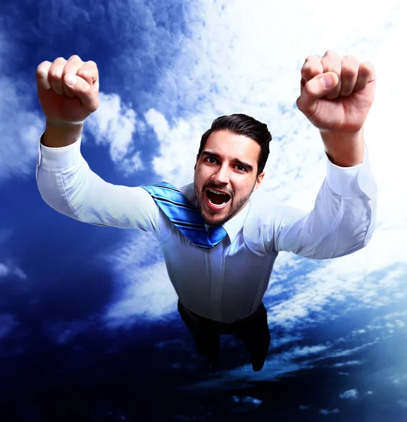 Happy businessman flying in the sky — Stock Photo, Image