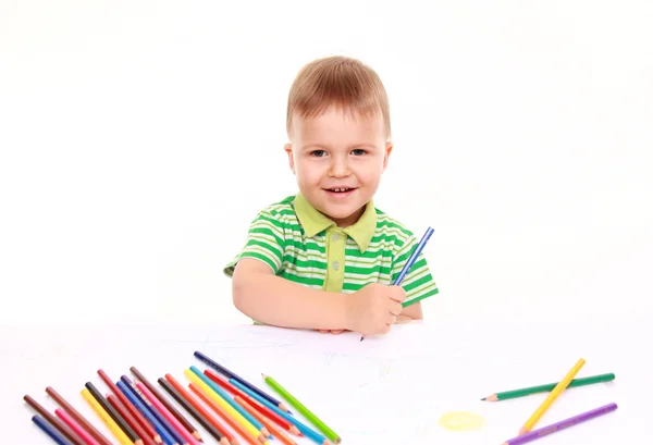 Kleine jongen op de tabel loting geïnspireerd met kleurpotloden, geïsoleerd op wit — Stockfoto