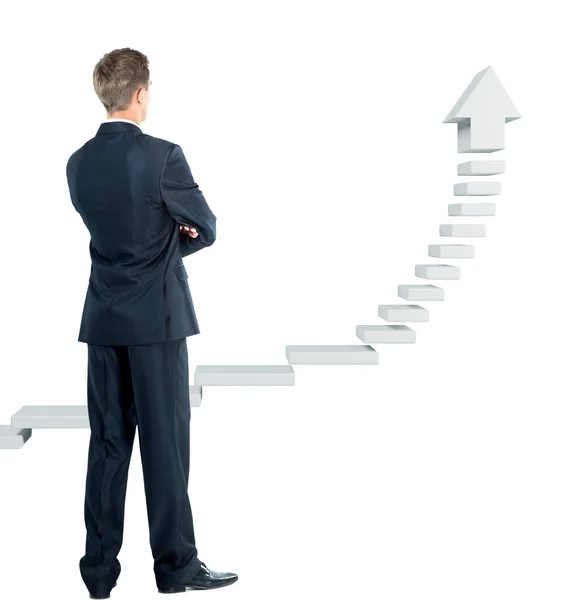 Jovem empresário olhando para uma escada — Fotografia de Stock