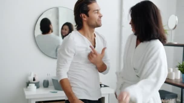 आकर्षक युवा जोड़े बाथरूम में नृत्य करते हुए उंगली दिखाते हुए मज़ा कर रहे हैं — स्टॉक वीडियो