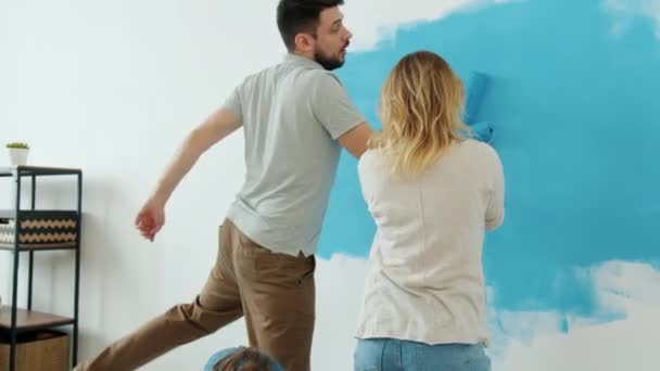 Creative parents and daughter painting wall at home and dancing enjoying renovation — Stock Footage Creative parents and daughter painting wall at home and dancing enjoying renovation Royalty Free Stock Video