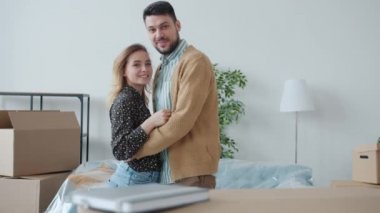 Güzel genç bir çiftin öpüştüğü bir portre. Sonra kameraya dönüp ellerinde yeni bir daire anahtarı tutuyorlar.