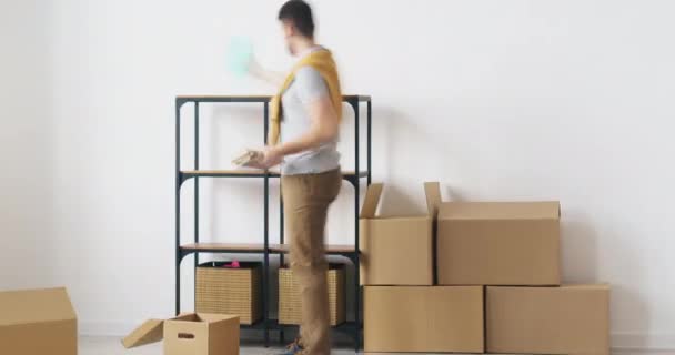 Time lapse of young family relocating to new house bringing furniture and belongings then resting on sofa — Stock Video