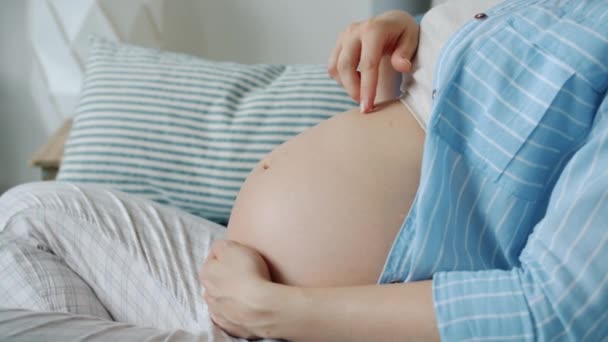 Close-up de mulher brincando com o bebê por nascer na barriga tocando barriga se divertindo em casa — Vídeo de Stock