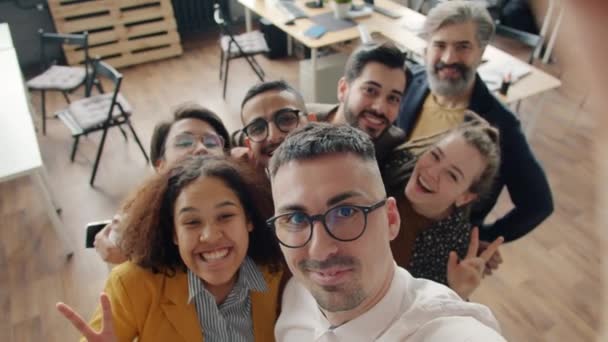 Slow motion portrait of cheerful office workers taking selfie in workplace smiling looking at camera — Stock Video