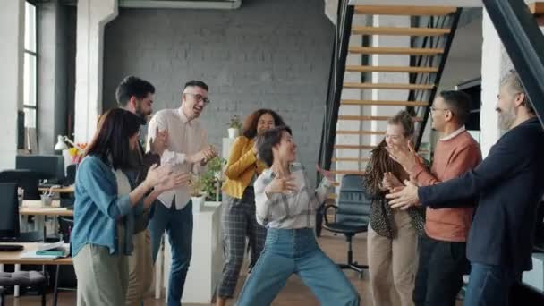 Slow motion of happy businesspeople dancing in office enjoying corporate party — Stock Video