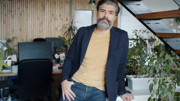 Portrait of mature office worker standing in workplace alone with serious face — Stock Video