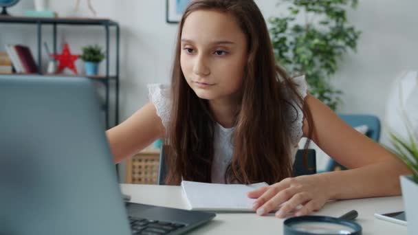 Niños serios que aprenden en línea que trabajan con el ordenador portátil y escriben ocupados con la educación en casa — Vídeo de stock