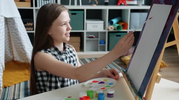 Pintura creativa para niños usando pinceles y caballete trabajando solos en casa — Vídeos de Stock