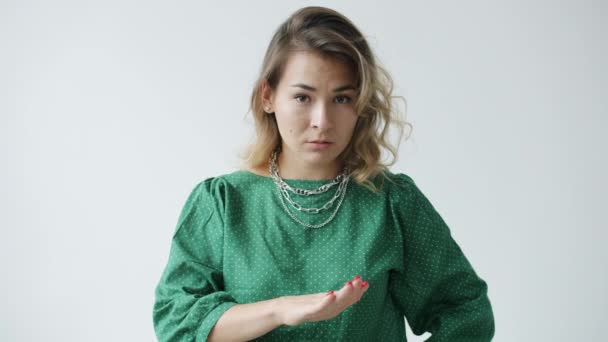 Portrait of dissatisfied young woman shaking head and gesturing meaning No on white background — Stock Video