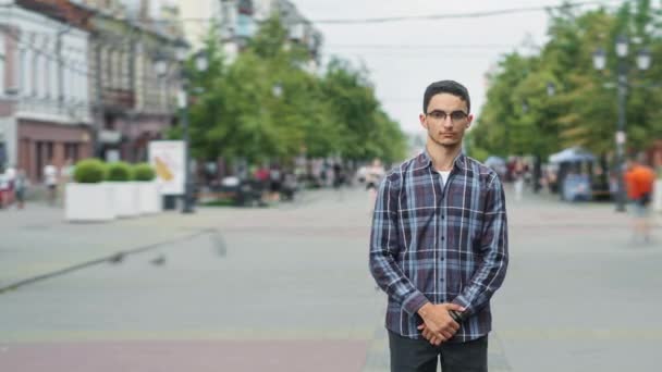 Time lapse portrait of good-looking Middle Eastern man standing in pedestrian street alone — Stock Video