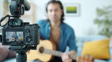 Video kamera ekranının ve gitarist vlog kaydedicinin arkaplandaki videosunu kapat