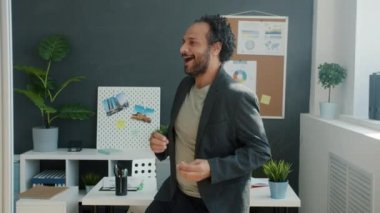 İş yerinde dans eden ve şarkı söyleyen neşeli Arap işçilerin ağır çekimleri