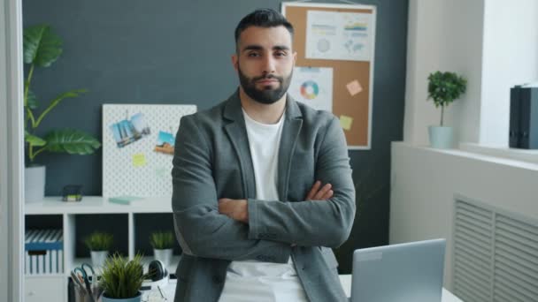 Attractive middle aged man standing in office with arms crossed then smiling looking at camera — Stock Video