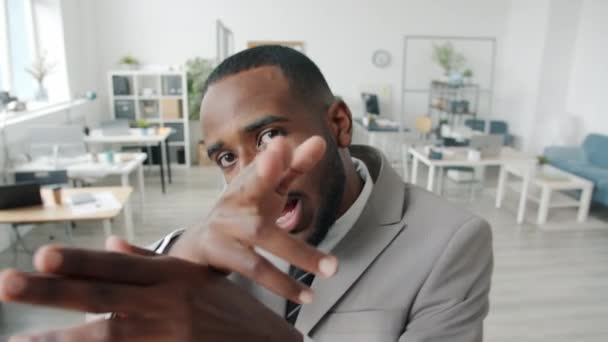 Modern afro-amerikansk sångare som framför hip-hop-sång och gester och tittar på kameran på kontoret — Stockvideo