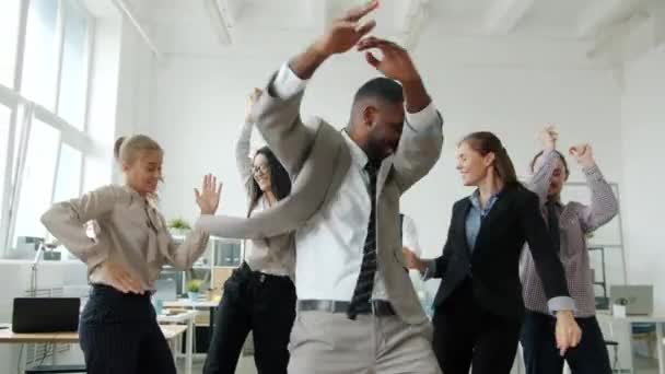 Joyful businesspeople dancing at corporate party enjoying work results celebrating victory — Stock Video