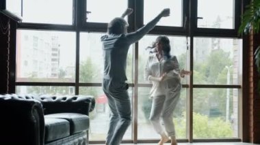 Yavaş çekim mutlu adam ve kadın dans panoramik arka planda eğleniyor