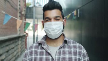 Orta Doğulu çekici bir kadının yavaş çekimde çekilmiş portresi. Maske takıyor.